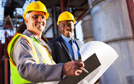 senior oil industry worker holding clipboard and blueprint with manager in plant
